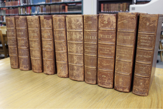 Photograph of the ten history of Keokuk scrapbooks in the Caleb F. Davis Collection